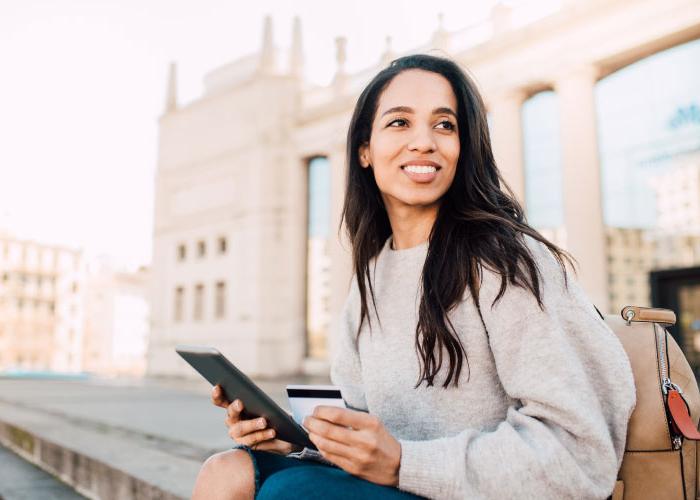 woman sitting with credit card and ipad